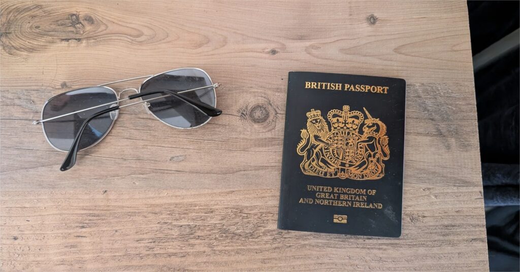 Passport and documents on a desk for planning a move to the UK